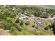 An aerial view shows a home with a screened pool and private backyard surrounded by trees at 9088 Gallup Cir, Spring Hill, FL 34608