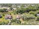 Aerial view showcasing properties with mature trees and lawns in a serene neighborhood setting at 9088 Gallup Cir, Spring Hill, FL 34608