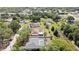 An aerial shot of a beautiful home with a large screened-in pool and fenced yard at 9088 Gallup Cir, Spring Hill, FL 34608