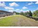 Expansive backyard with a screened-in pool, a charming dock, and a lush green lawn at 9088 Gallup Cir, Spring Hill, FL 34608
