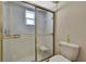 Bathroom featuring a glass door shower and a toilet at 9088 Gallup Cir, Spring Hill, FL 34608