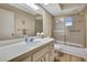 Bright bathroom featuring a single sink vanity, large mirror, and shower at 9088 Gallup Cir, Spring Hill, FL 34608