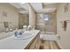 Bathroom featuring a single sink vanity, large mirror, and glass shower at 9088 Gallup Cir, Spring Hill, FL 34608