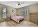 Cozy bedroom featuring natural light, a ceiling fan, and minimalist décor at 9088 Gallup Cir, Spring Hill, FL 34608