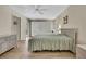 Comfortable bedroom featuring light wood floors, ceiling fan, and ample closet space at 9088 Gallup Cir, Spring Hill, FL 34608