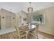 Dining area featuring hardwood floors, contemporary lighting, and a large window for abundant natural light at 9088 Gallup Cir, Spring Hill, FL 34608