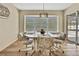 Inviting dining area with a bay window view, a chandelier, and a table set for a meal at 9088 Gallup Cir, Spring Hill, FL 34608