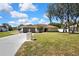 Beautiful home with well-kept lawn, featuring a spacious driveway and lovely landscaping at 9088 Gallup Cir, Spring Hill, FL 34608