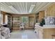 Spacious garage with shelving and tile flooring, perfect for workshop or storage at 9088 Gallup Cir, Spring Hill, FL 34608