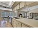 Bright kitchen with light countertops, stainless steel appliances, and an open view to the dining and living areas at 9088 Gallup Cir, Spring Hill, FL 34608