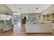 Bright living room with hardwood flooring, an open layout, neutral color palette, and access to the lanai at 9088 Gallup Cir, Spring Hill, FL 34608