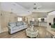 Cozy living area with hardwood floors, neutral paint, a ceiling fan, and an adjacent dining area at 9088 Gallup Cir, Spring Hill, FL 34608