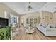 Open-concept living space featuring vaulted ceilings, hardwood floors, and neutral walls, filled with natural light at 9088 Gallup Cir, Spring Hill, FL 34608