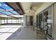 Patio area featuring outdoor furniture, a fan, and a screened-in area at 9088 Gallup Cir, Spring Hill, FL 34608