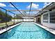 A large, screened pool shimmers in the sunlight, offering a refreshing and private backyard oasis at 9088 Gallup Cir, Spring Hill, FL 34608