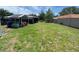 Spacious backyard featuring a shed and screened-in patio, perfect for outdoor entertaining and relaxation at 9186 Patio Ct, Spring Hill, FL 34608