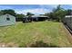 Expansive backyard with a shed, screened patio, and privacy fence, ideal for outdoor activities and enjoying nature at 9186 Patio Ct, Spring Hill, FL 34608