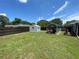 Large backyard showcasing a shed and sheltered area, offering ample space for gardening or Gathering fun at 9186 Patio Ct, Spring Hill, FL 34608
