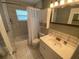 Compact bathroom with a shower-tub combination, a large vanity, and updated fixtures at 9186 Patio Ct, Spring Hill, FL 34608