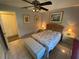 Bedroom with natural light, ceiling fan, tile flooring, and a spacious closet at 9186 Patio Ct, Spring Hill, FL 34608