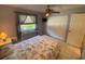 Bedroom with natural light, ceiling fan, tile flooring, and a spacious closet at 9186 Patio Ct, Spring Hill, FL 34608