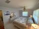 Cozy bedroom featuring tile flooring, a ceiling fan, and views of an ensuite bathroom at 9186 Patio Ct, Spring Hill, FL 34608