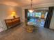 Cozy dining area featuring carpet flooring, decorative lighting, and access to the patio at 9186 Patio Ct, Spring Hill, FL 34608