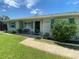 Welcoming front porch with a bench and colorful shutters, enhancing curb appeal at 9186 Patio Ct, Spring Hill, FL 34608