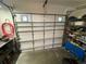 White overhead garage door equipped with automatic opener, safety features, and small panes at 9186 Patio Ct, Spring Hill, FL 34608