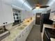 Bright kitchen featuring white cabinets, granite countertops, stainless steel appliances, and a garden view at 9186 Patio Ct, Spring Hill, FL 34608