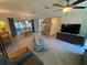 Bright living room features a ceiling fan, modern furniture, and access to the patio at 9186 Patio Ct, Spring Hill, FL 34608