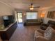 Bright living room featuring neutral decor, modern furniture, and natural lighting at 9186 Patio Ct, Spring Hill, FL 34608