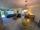 Spacious living room featuring neutral decor, decorative lighting, and access to other rooms at 9186 Patio Ct, Spring Hill, FL 34608
