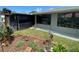 Inviting screened patio and garden with lush flowers, creating a perfect space for relaxation and enjoying the outdoors at 9186 Patio Ct, Spring Hill, FL 34608
