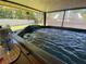 Spacious above-ground pool with lights and jets in a screened in enclosure at 9186 Patio Ct, Spring Hill, FL 34608