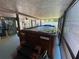 Screened-in above-ground pool with steps and safety handles at 9186 Patio Ct, Spring Hill, FL 34608