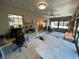 Bright sun room featuring tile flooring, neutral walls, and access to the backyard at 9186 Patio Ct, Spring Hill, FL 34608
