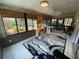 Bright sunroom with tile floor, brick accent wall, and multiple windows overlooking the backyard garden at 9186 Patio Ct, Spring Hill, FL 34608