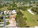 High-angle view of homes by a golf course with trees, highlighting community layout at 9355 French Quarters Cir, Weeki Wachee, FL 34613