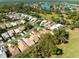 Overhead view of a neighborhood near a golf course and lake, showcasing community layout at 9355 French Quarters Cir, Weeki Wachee, FL 34613