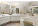 Bright bathroom featuring a soaking tub, vanity with sink, and neutral color scheme at 9355 French Quarters Cir, Weeki Wachee, FL 34613