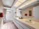 Bright bathroom with dual sinks, a large mirror, and bathtub with shower combination at 9355 French Quarters Cir, Weeki Wachee, FL 34613