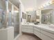 Elegant bathroom with glass-enclosed shower, and a vanity with ample countertop space at 9355 French Quarters Cir, Weeki Wachee, FL 34613