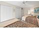 Comfortable bedroom with twin beds, a ceiling fan, and ample closet space at 9355 French Quarters Cir, Weeki Wachee, FL 34613