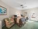 Inviting bedroom with twin beds, a cozy armchair, and ample natural light at 9355 French Quarters Cir, Weeki Wachee, FL 34613