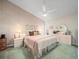 Spacious main bedroom with ceiling fan, soft neutral tones, and plenty of natural light at 9355 French Quarters Cir, Weeki Wachee, FL 34613