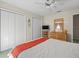 Spacious bedroom with ceiling fan, closet, and dresser, creating a welcoming atmosphere at 9355 French Quarters Cir, Weeki Wachee, FL 34613