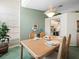 Cozy dining room featuring a light wood table setting for four and a decorative chandelier at 9355 French Quarters Cir, Weeki Wachee, FL 34613