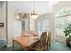 Dining room with natural light from an arched window, wooden table, and a decorative light fixture at 9355 French Quarters Cir, Weeki Wachee, FL 34613
