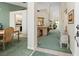 Spacious hallway with neutral walls, light green carpet, and views into other rooms of the house at 9355 French Quarters Cir, Weeki Wachee, FL 34613